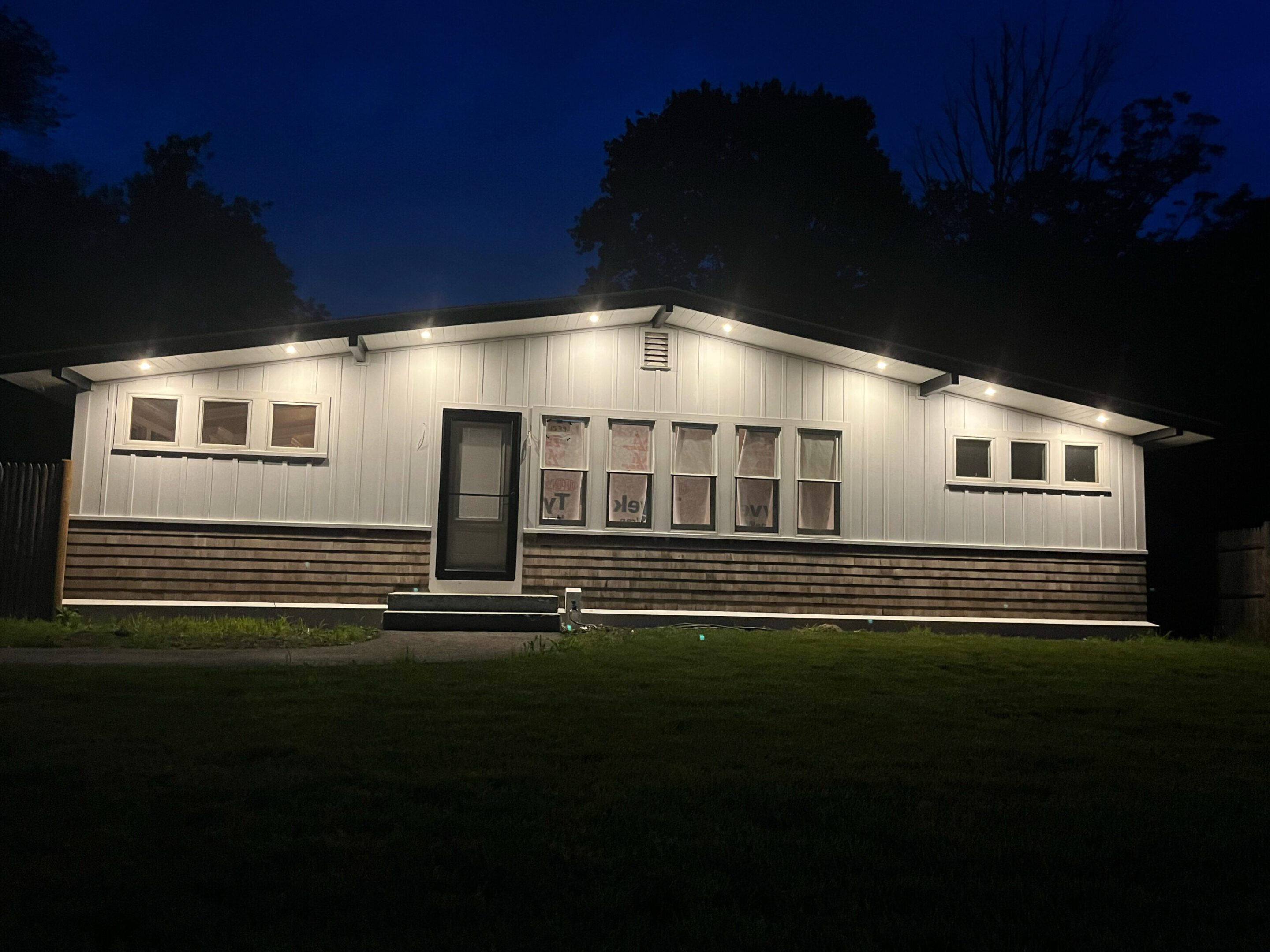 A house with lights on the outside of it