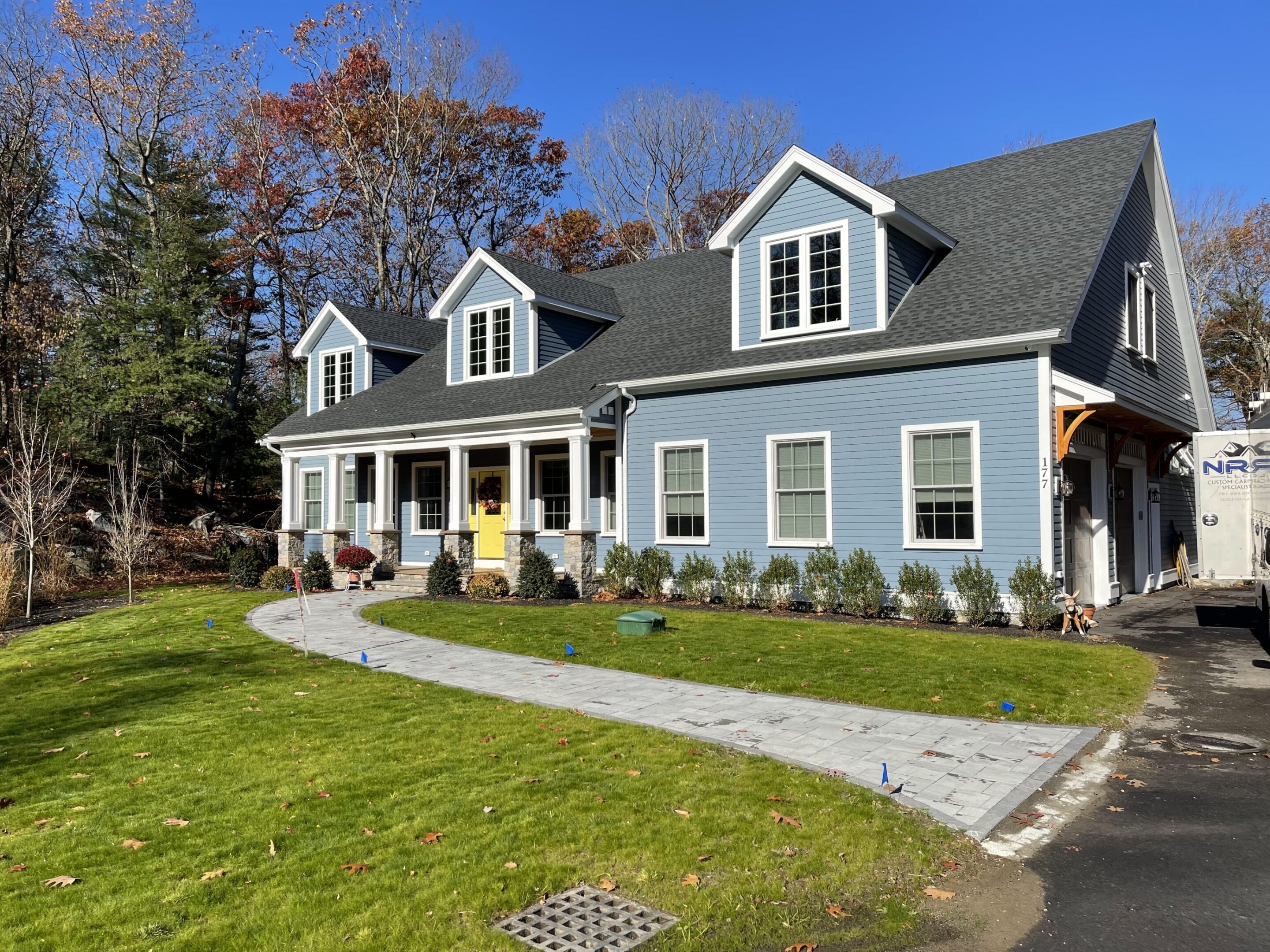 A blue house with yellow door and white trim.