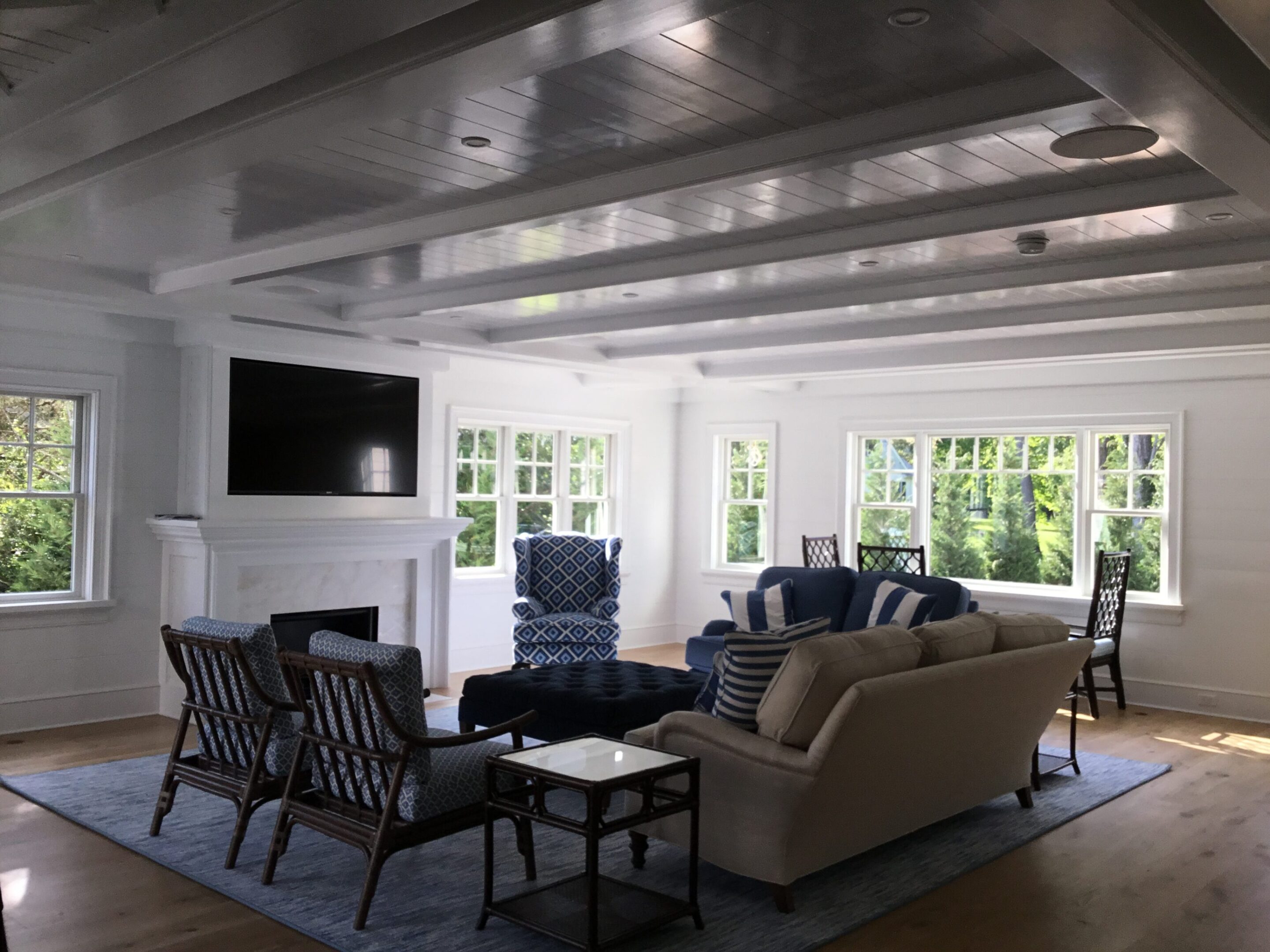 A living room with couches, chairs and tables.