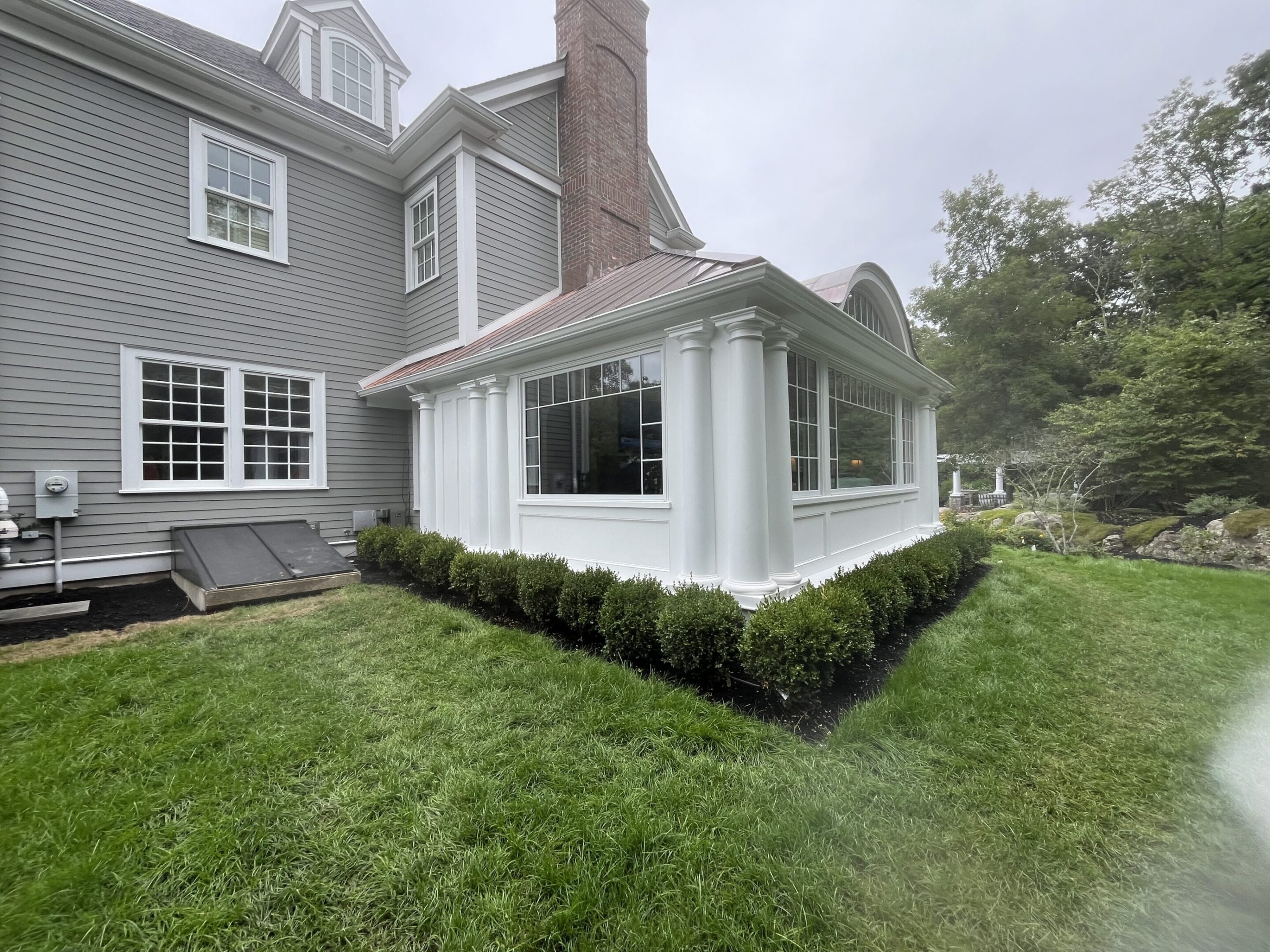A house with a lot of bushes in the yard
